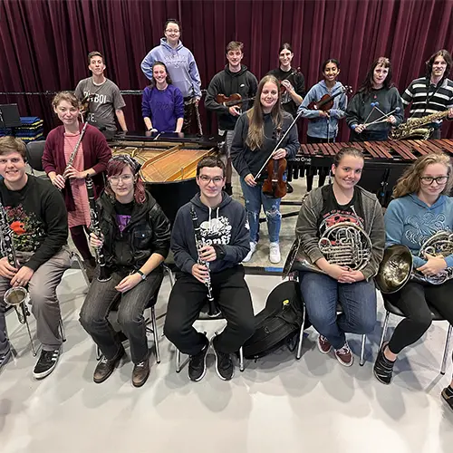Student posing with their instruments
