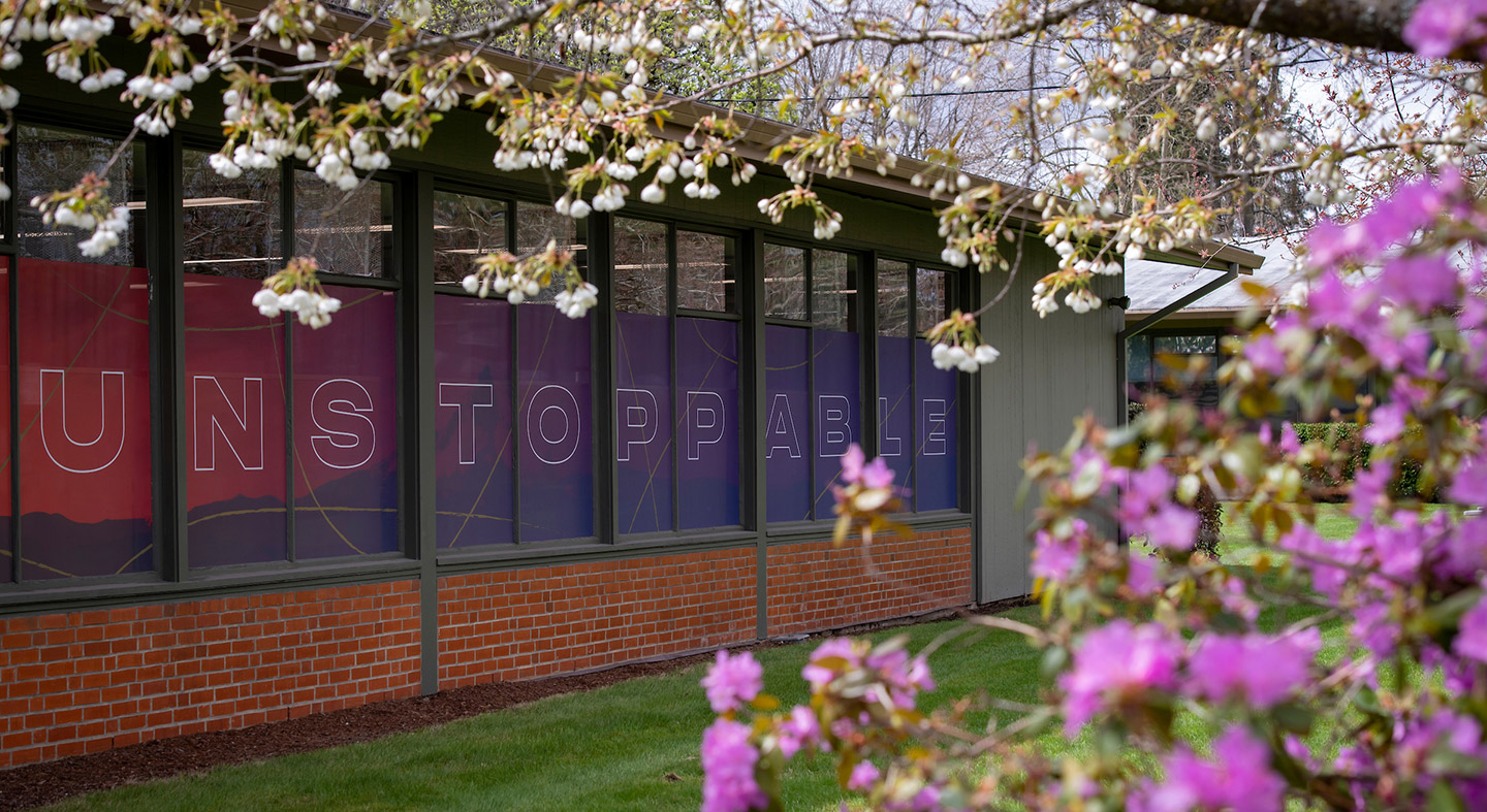 A building on the Portland campus with the word "Unstoppable" across the windows.