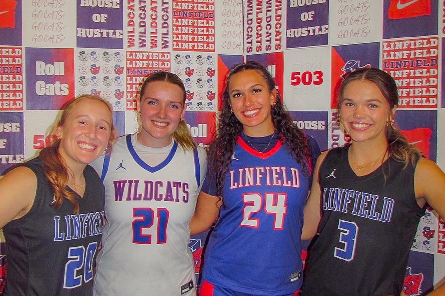 Miki posing for a photo with three teammates in basketball uniforms.
