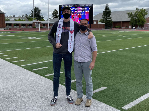 Ethan Myers accepting his athlete stole before the 2021 graduation 