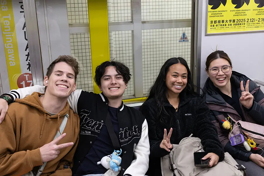 Rocco, Marco, Kami, Tina riding a subway.