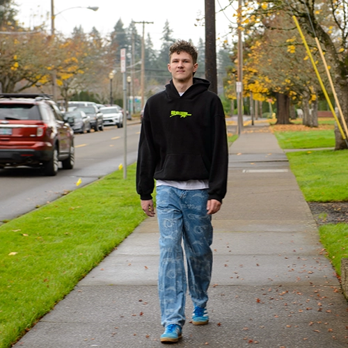 Kris walking on campus.