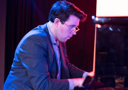 Zach Gulaboff Davis '14 playing the piano.