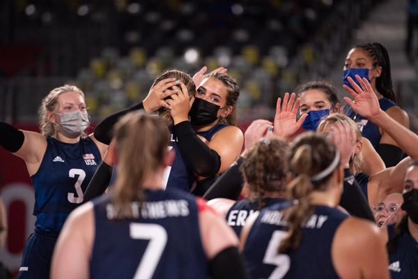 Annie and her team celebrating with hugs and high fives after a win