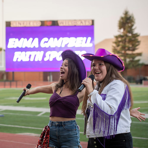 Emma and Faith rallying the student body at Cat Camp 2023.