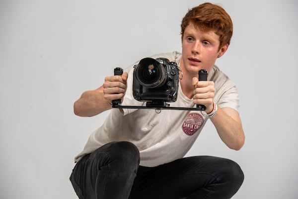 Ben filming video while riding a skateboard