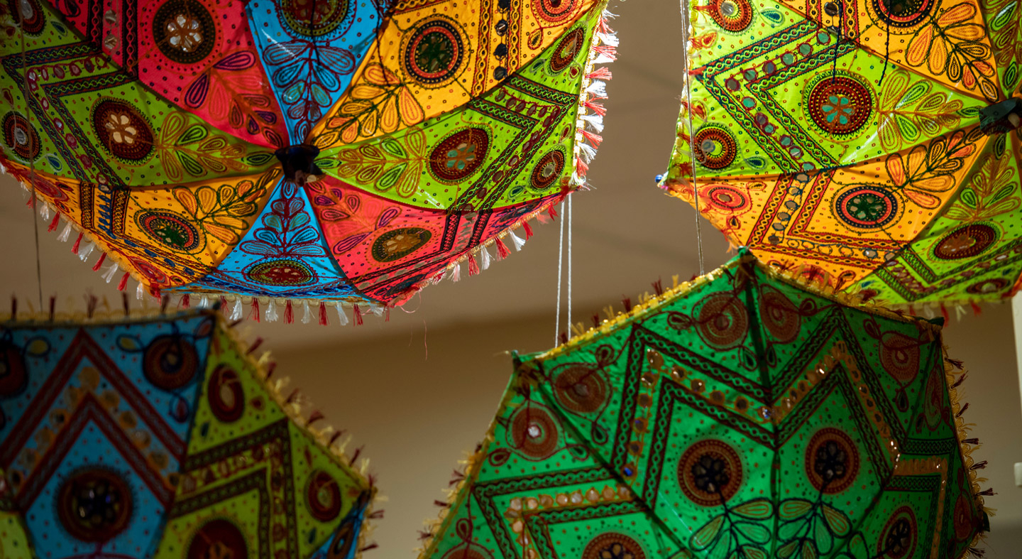 Color umbrellas decorate the ceiling at the Diwali celebration