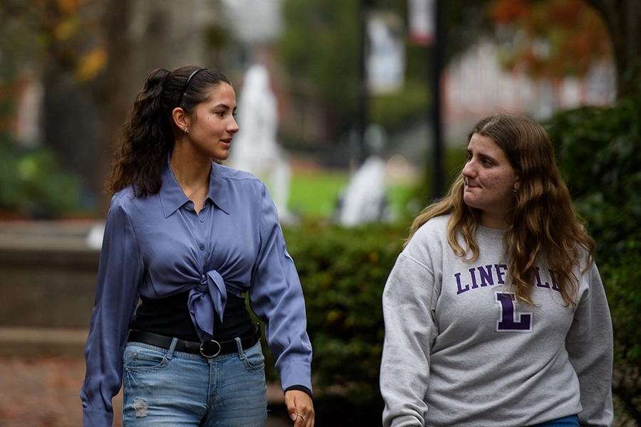 Kalina walking through campus with a friend.
