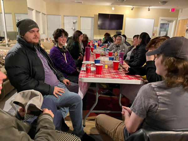 LUP members sitting around a table at Friendsgiving.