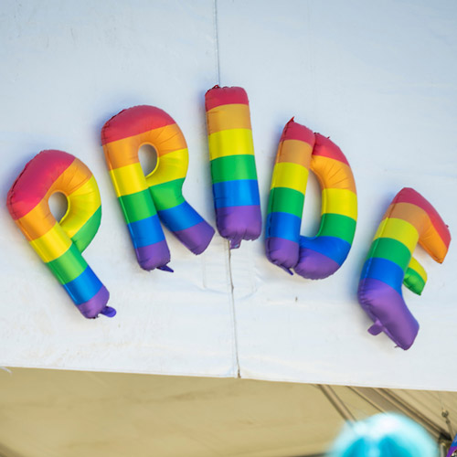 The word "Pride" spelled out in rainbow-colored balloons.