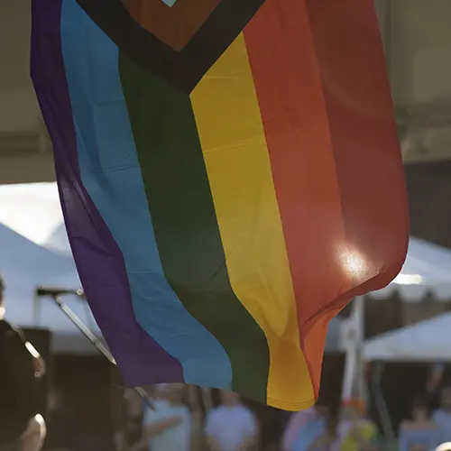 a pride flag hanging outside.
