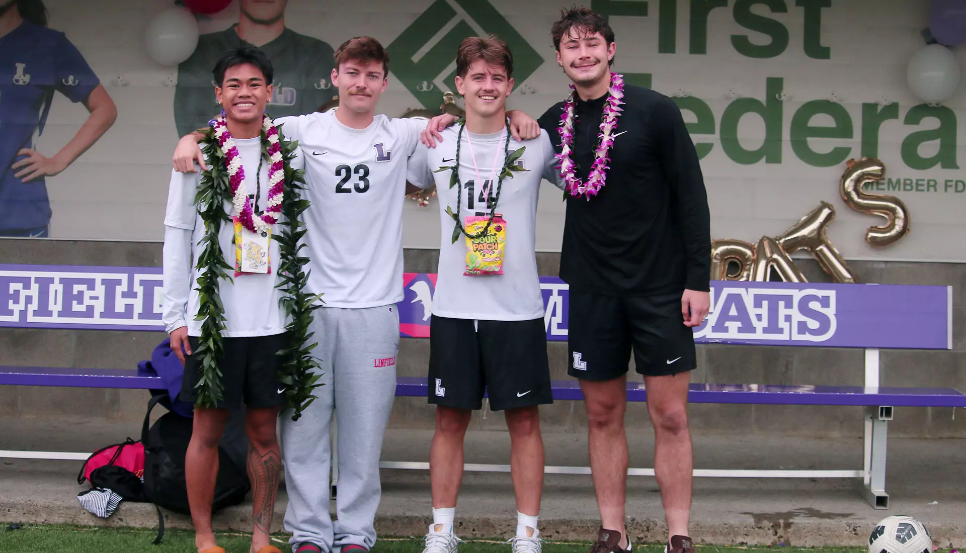 Anson and three other soccer seniors pose as part of senior day