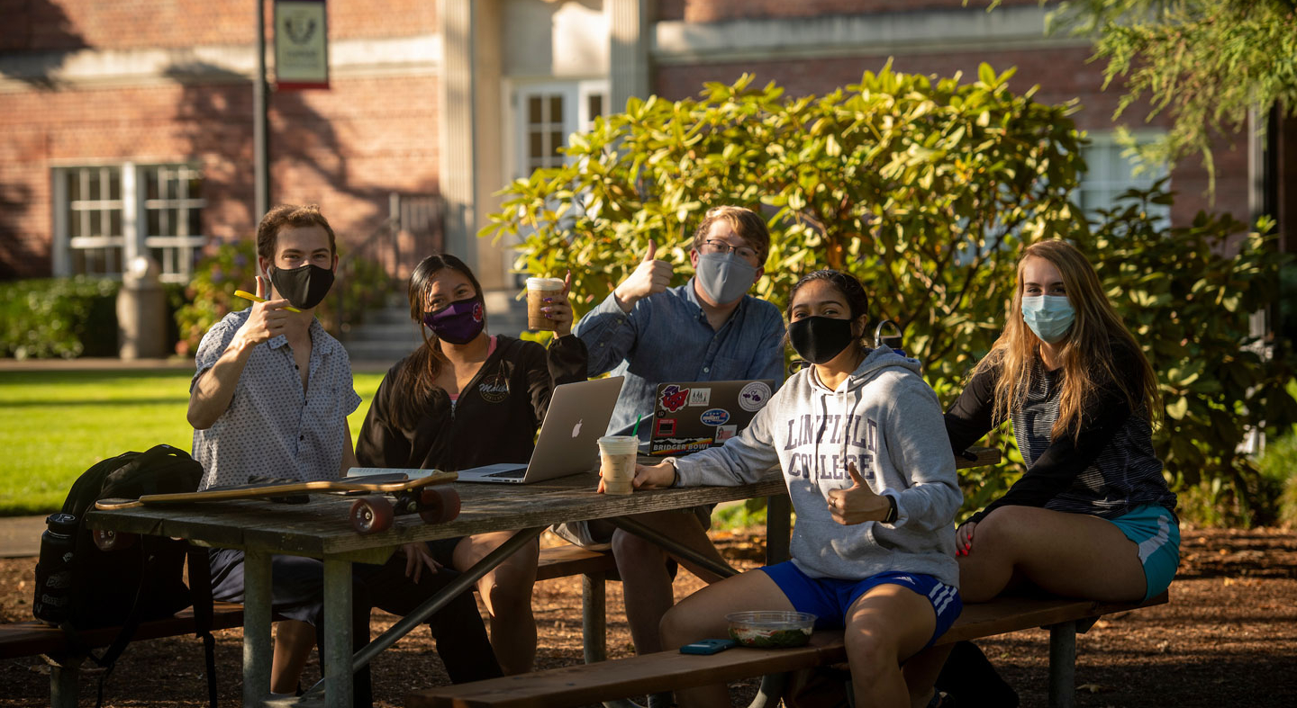 A group of Linfield students studying outside in early October.