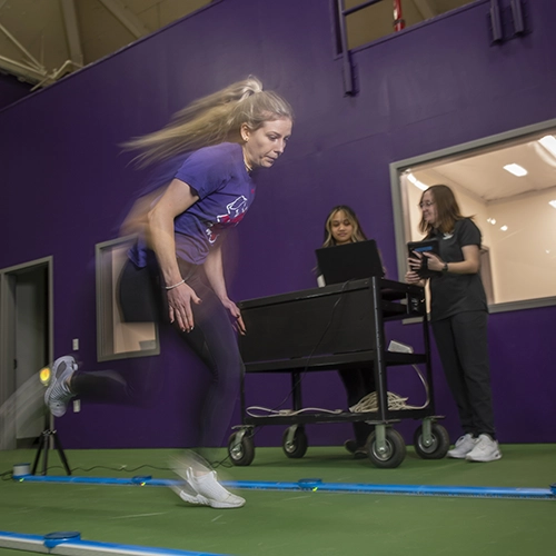 sports science student studying data chart on a monitor