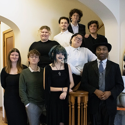 The directors posing on a set of stairs.