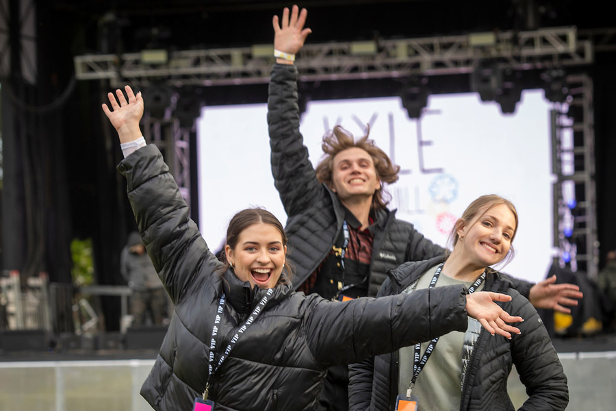 Three excited ASLU members in front of the stage at Wildstock 2022.