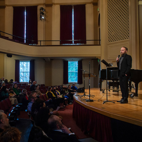 Jeremy Richards speaking before the United for Ukraine benefit concert in Ice Auditorium