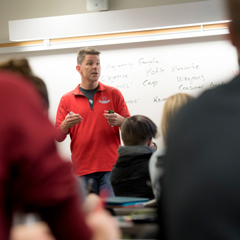 Professor Eric Schuck teaching an economics class at Linfield University