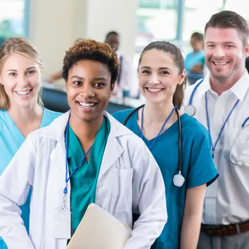 4 medical professionals looking at a camera.