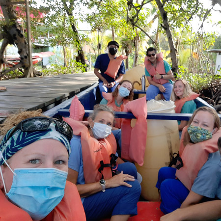 RN to BSN student with seven fellow volunteers boarding a boat in Panama