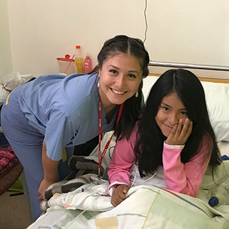 A nursing student with a young patient in a hospital setting.