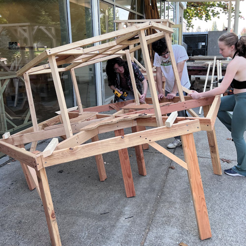 students building a dimensional wood structure