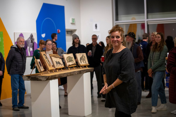 Belle speaking to a crowd at the opening of her art exhibit, Bloom.