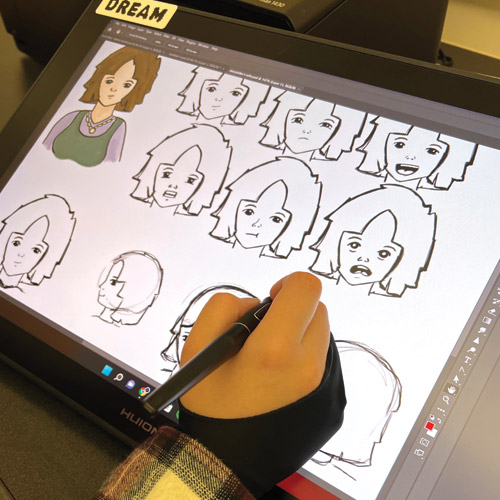 a student drawing art on a drawing tablet