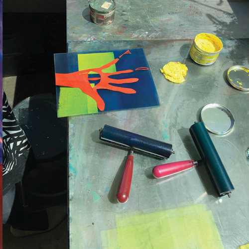 A student's print work project of a colorful handprint