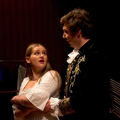 two students performing in an opera