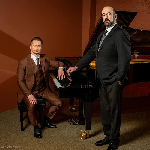 Anton Belov, and Stanislav Serebriannikov posing by a piano