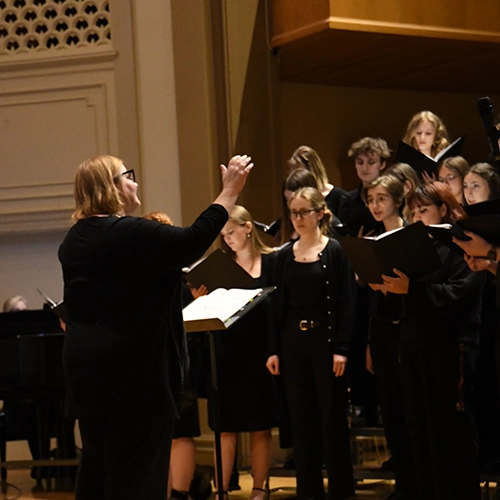 Students singing a choir performance.