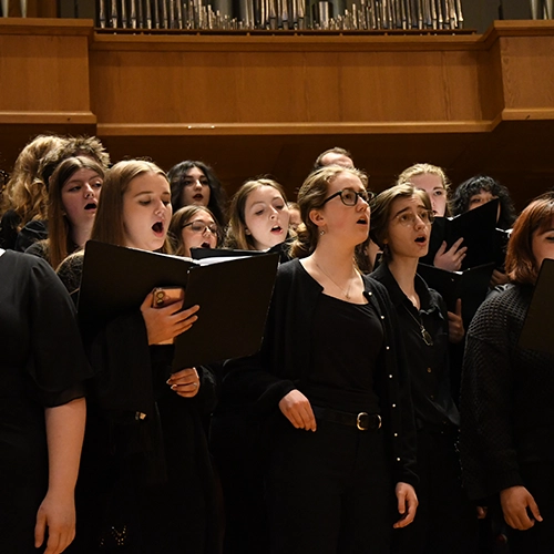 Students singing a choir performance.