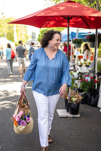 Maria shopping at a farmers market flower stand