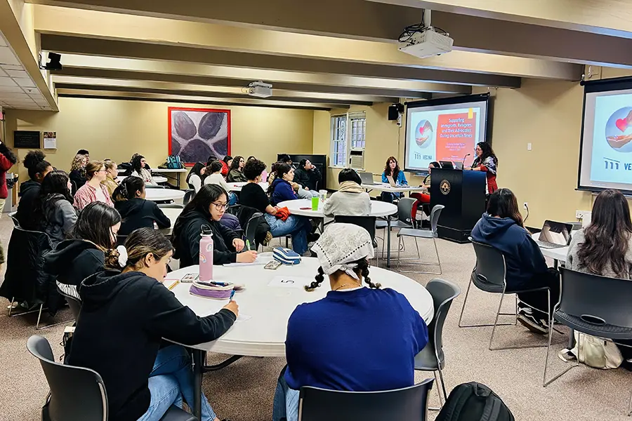 Attendees listening to a presenter at the Crossing Borders presentation.