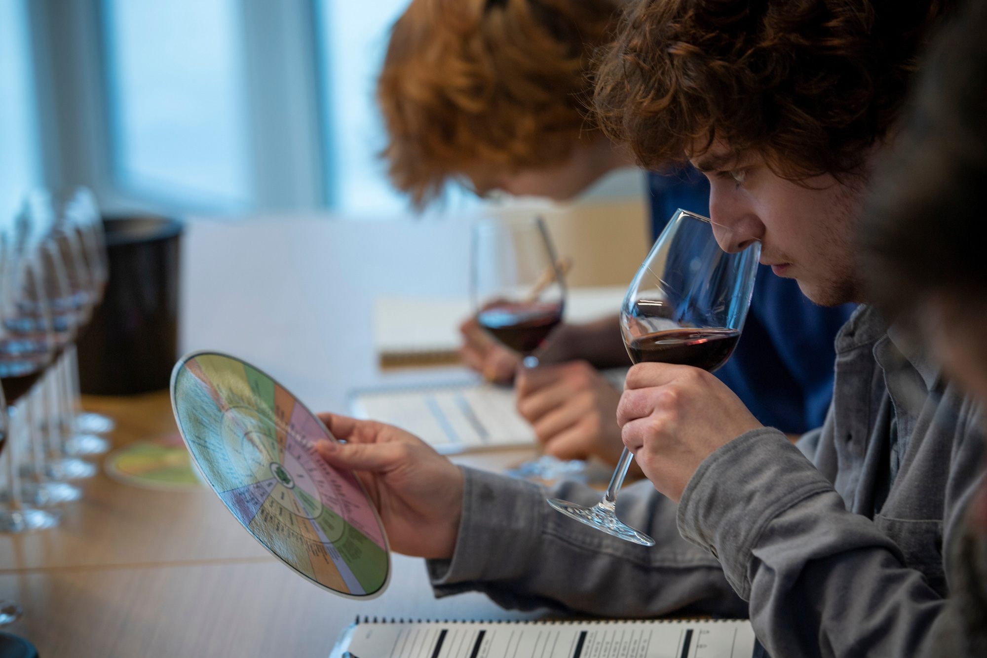 students smelling wine at a wine class.