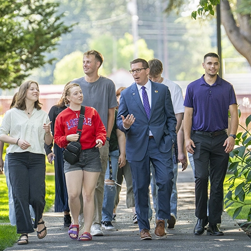 Mark walking through campus with students.