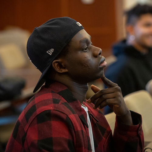 Male student listening intently in class.