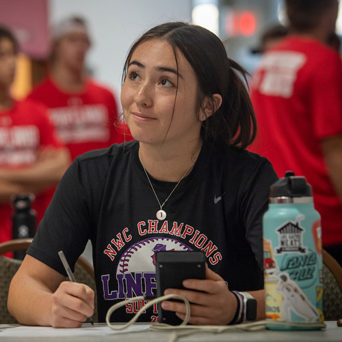 female grad student collecting data on an athlete