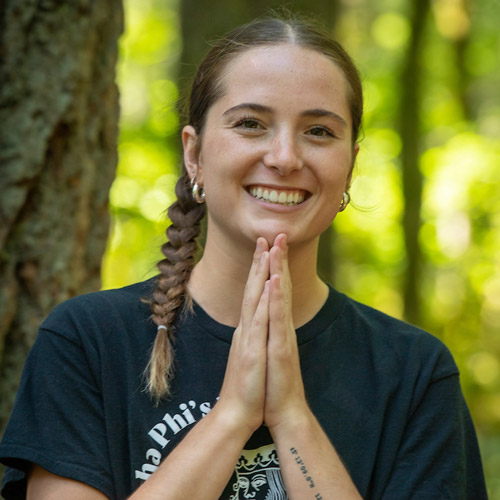 Female student with her hands together in prayer or in gratitude.