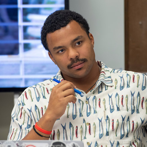 male student listening intently in class for the Master of Science in business at Linfield