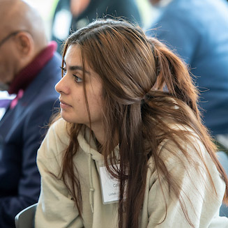 Female student listening to the panel at the BIPOC Wine Symposium.