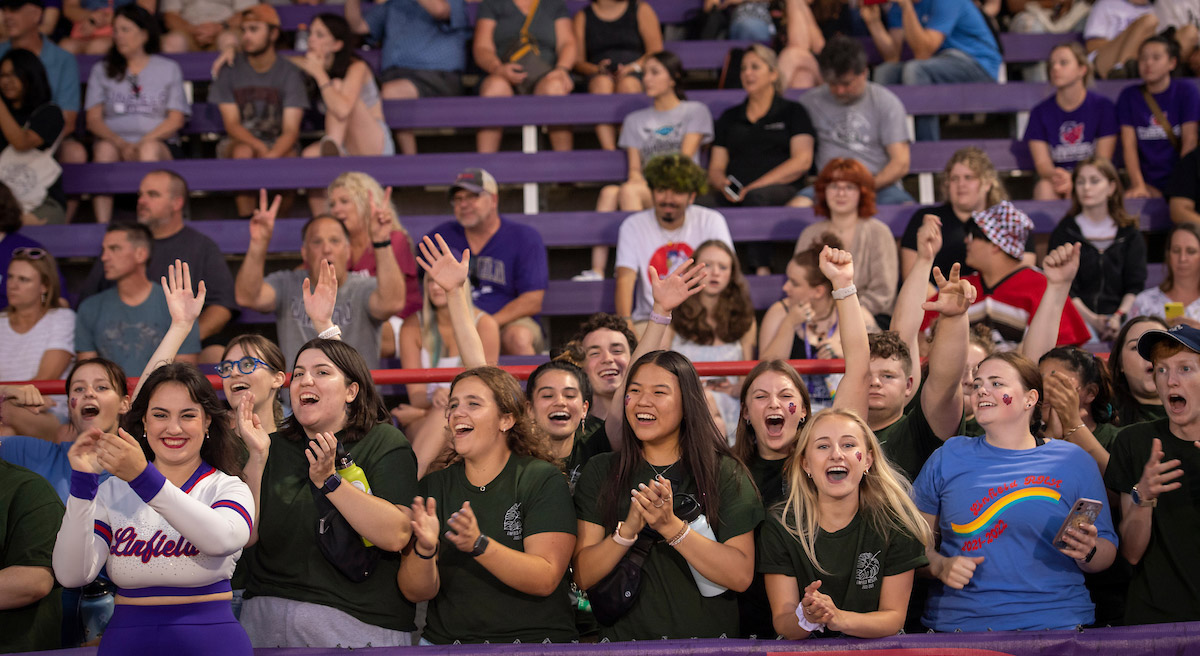 Students cheering in the bleachers.