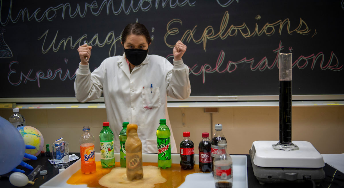 female chemistry student conducting combustion experiment in lab