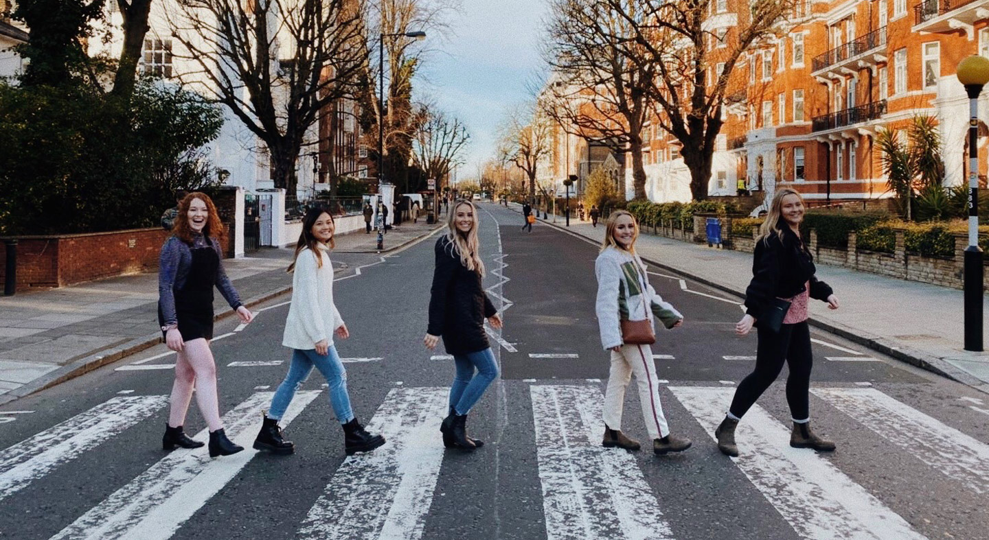 Five students crossing Abbey Road in England