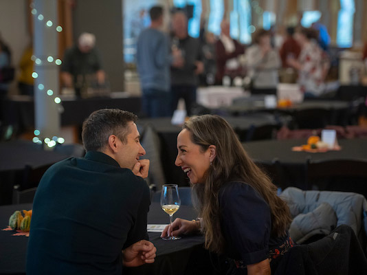 a couple sharing a glass of wine.