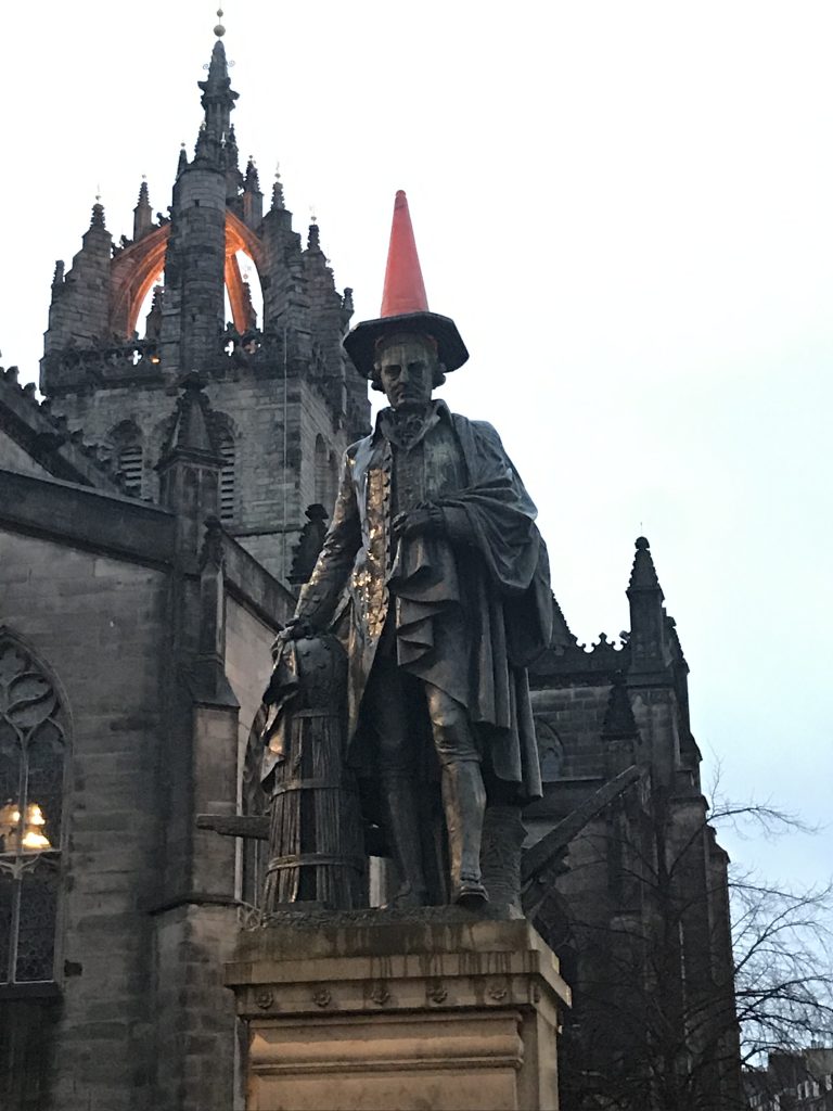 A statue of Adam Smith and a street cone, passed on the ghost tour.