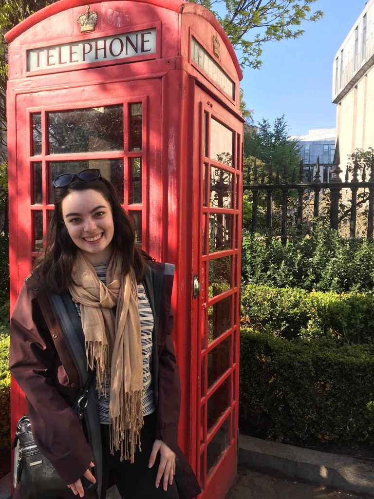Jordan Keller posing with a telephone booth for the "London aesthetic" outside St. Paul's Cathedral