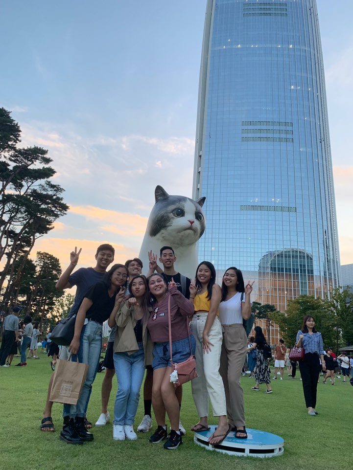 My friends and I behind the tower, and large cat. 