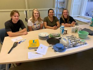 4 people sitting behind a table with cooking supplies on it to make palatschinken